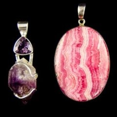 Purple amethyst pendant beside a pink rhodochrosite pendant