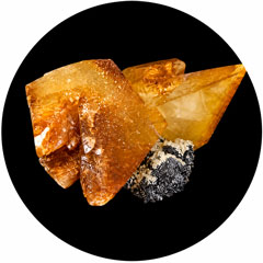 An orange calcite crystal in a pointed crystal formation