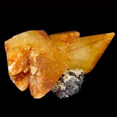 An orange calcite crystal in a pointed crystal formation