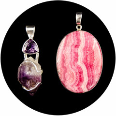 Purple amethyst pendant beside a pink rhodochrosite pendant