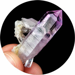 Small common pink opal specimen being held by a hand